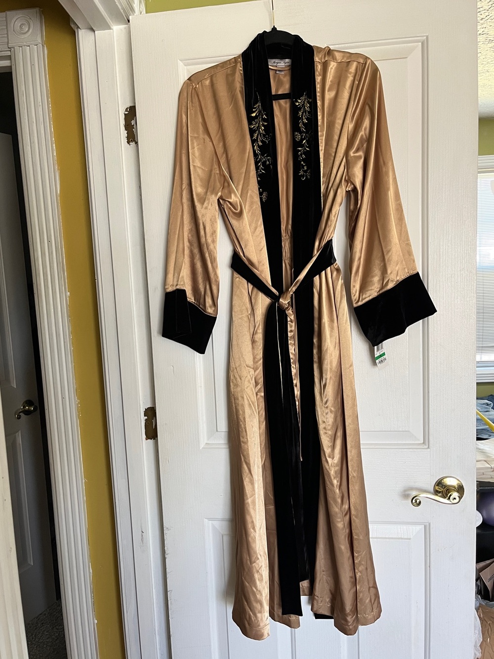 Gold satin robe with black velvet trim and black floral embroidery on the collar